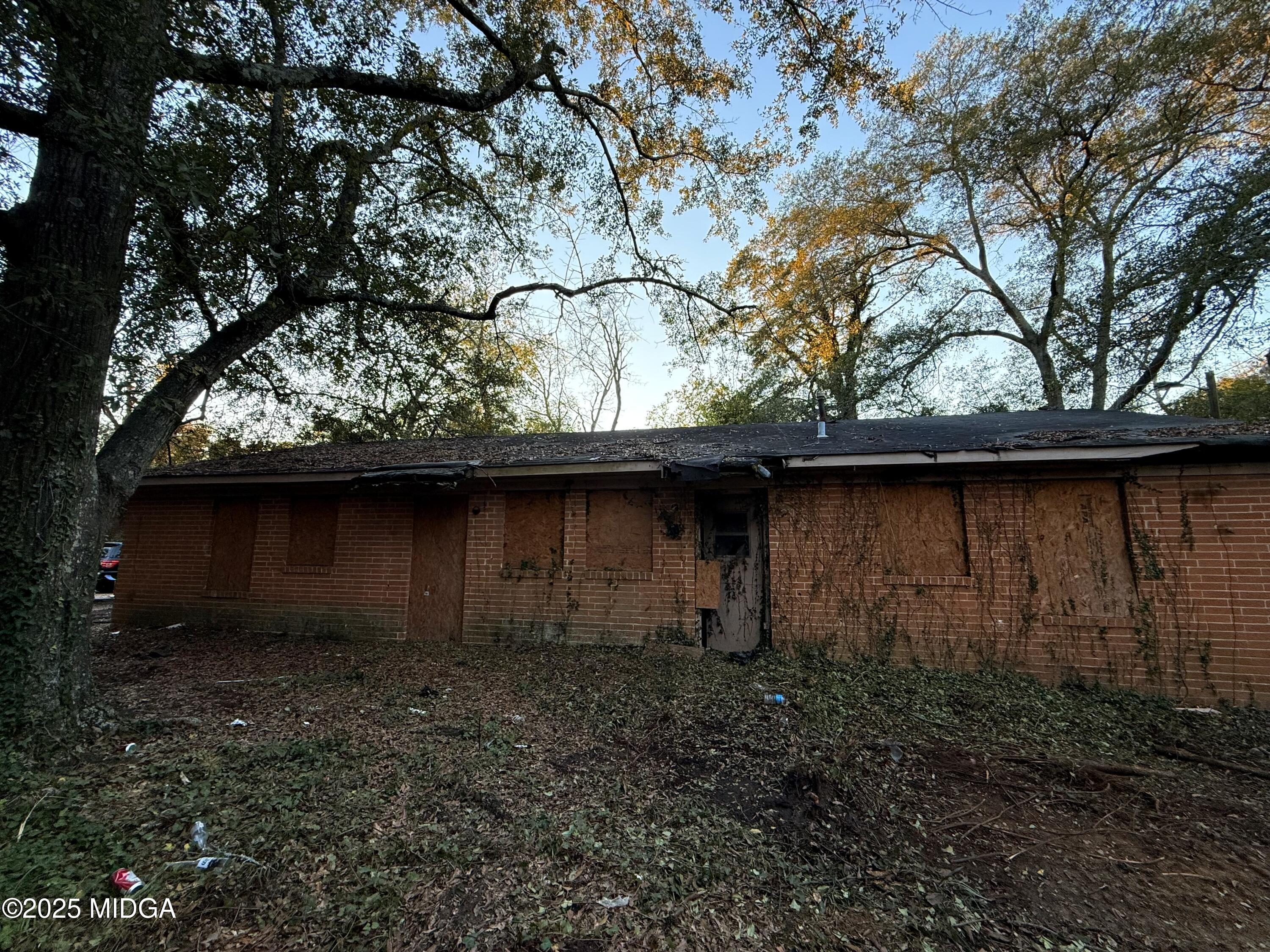 2753 Roy Street Macon, GA 31204 - Photo 3 of 8 a backyard of a house with lots of plants and wooden fence