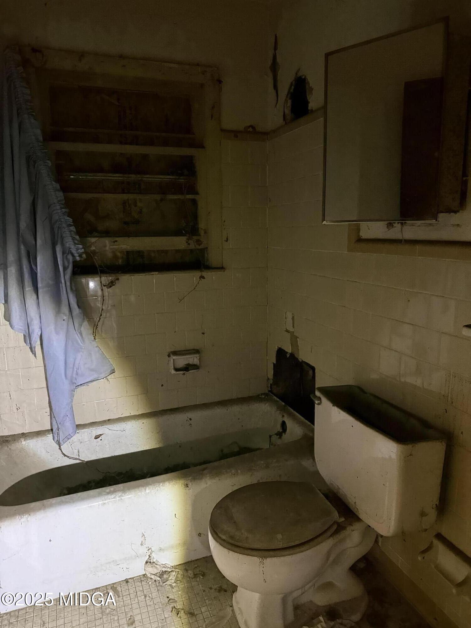 2753 Roy Street Macon, GA 31204 - Photo 4 of 8 a toilet sitting in a bathroom next to a sink