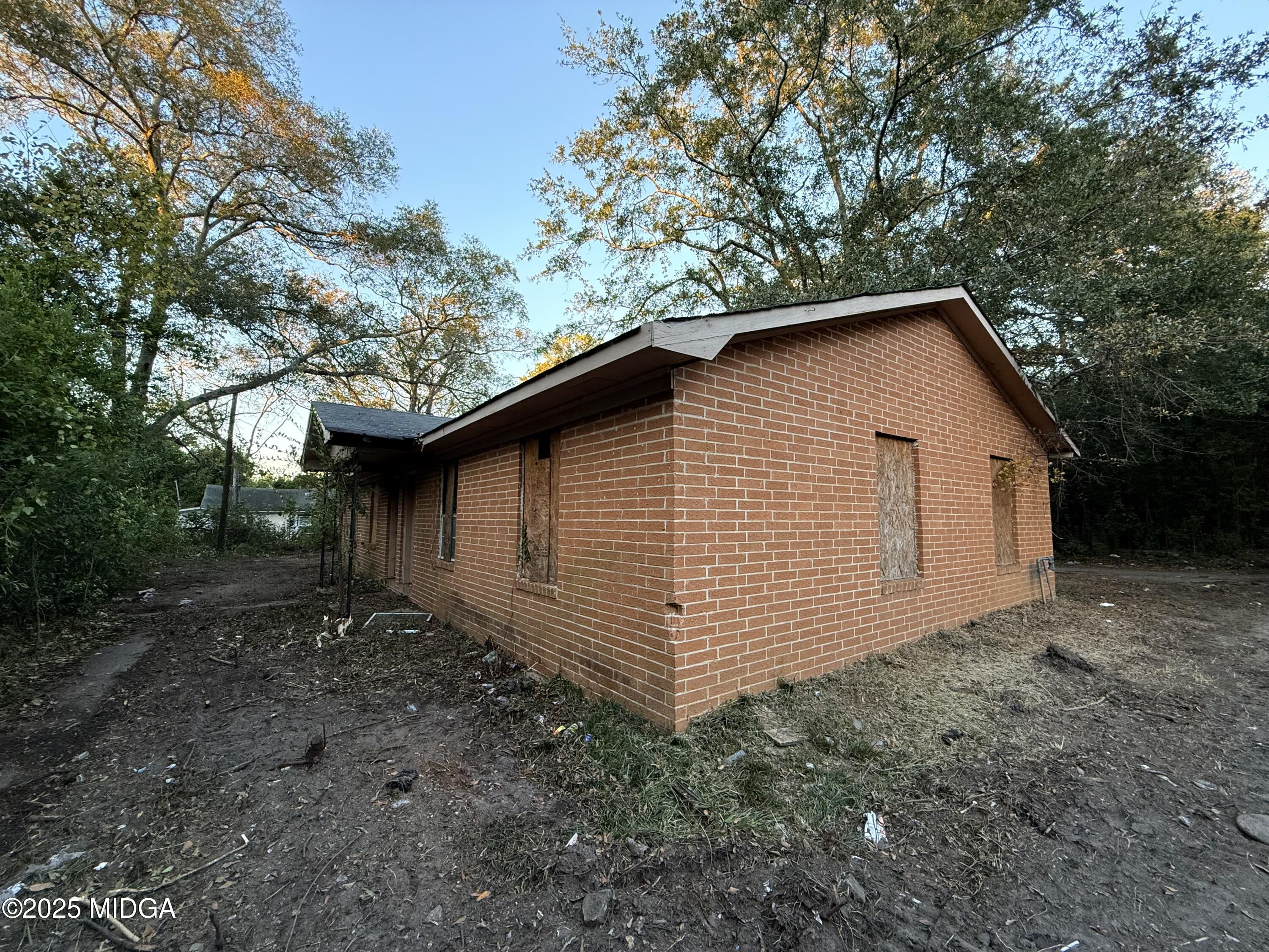 2753 Roy Street Macon, GA 31204 - Photo 7 of 8 a backyard of a house with lots of green space