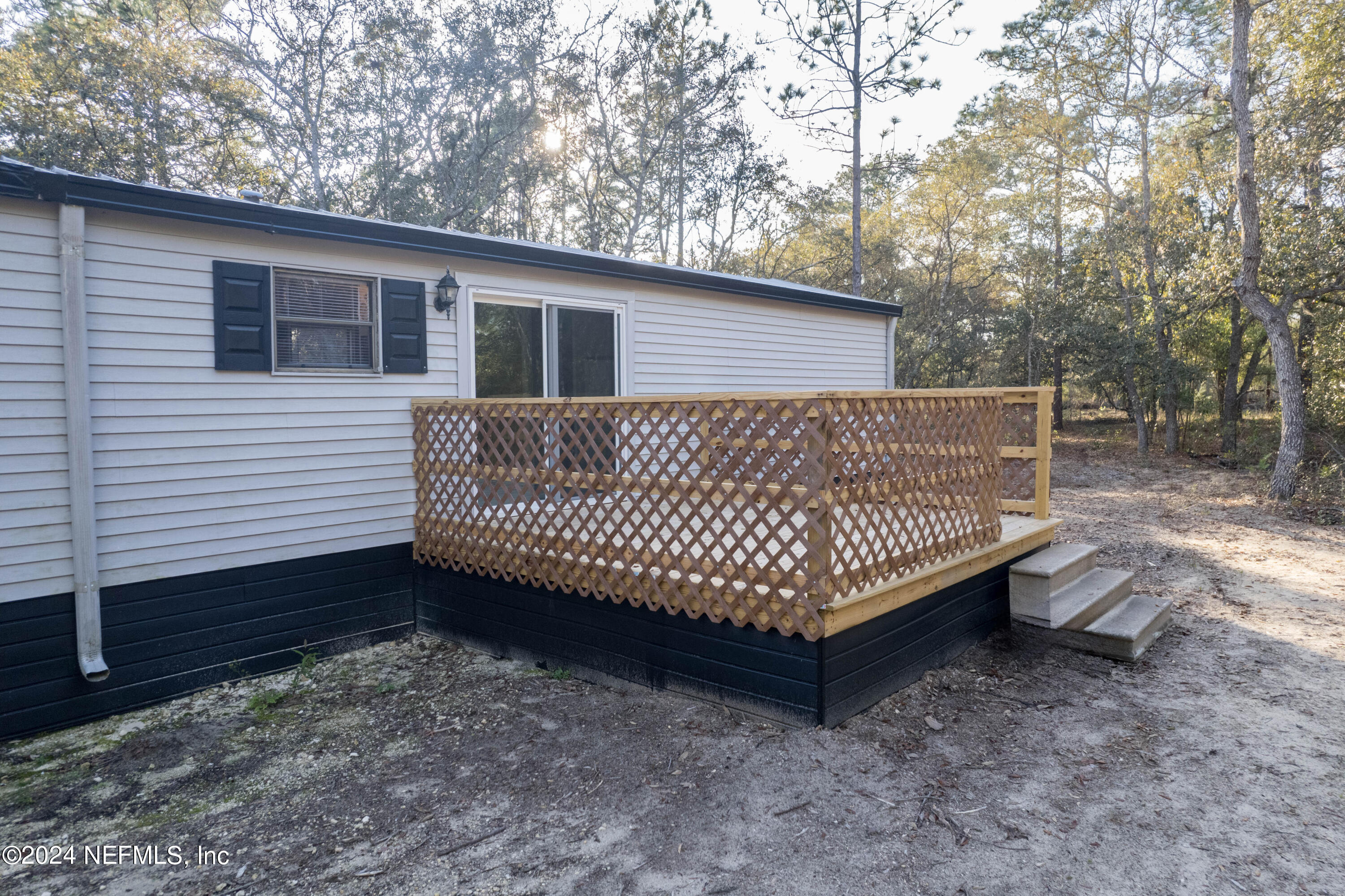 6787 Deer Springs Road Keystone Heights, FL 32656 - Photo 12 of 54 a view of outdoor space with deck and yard