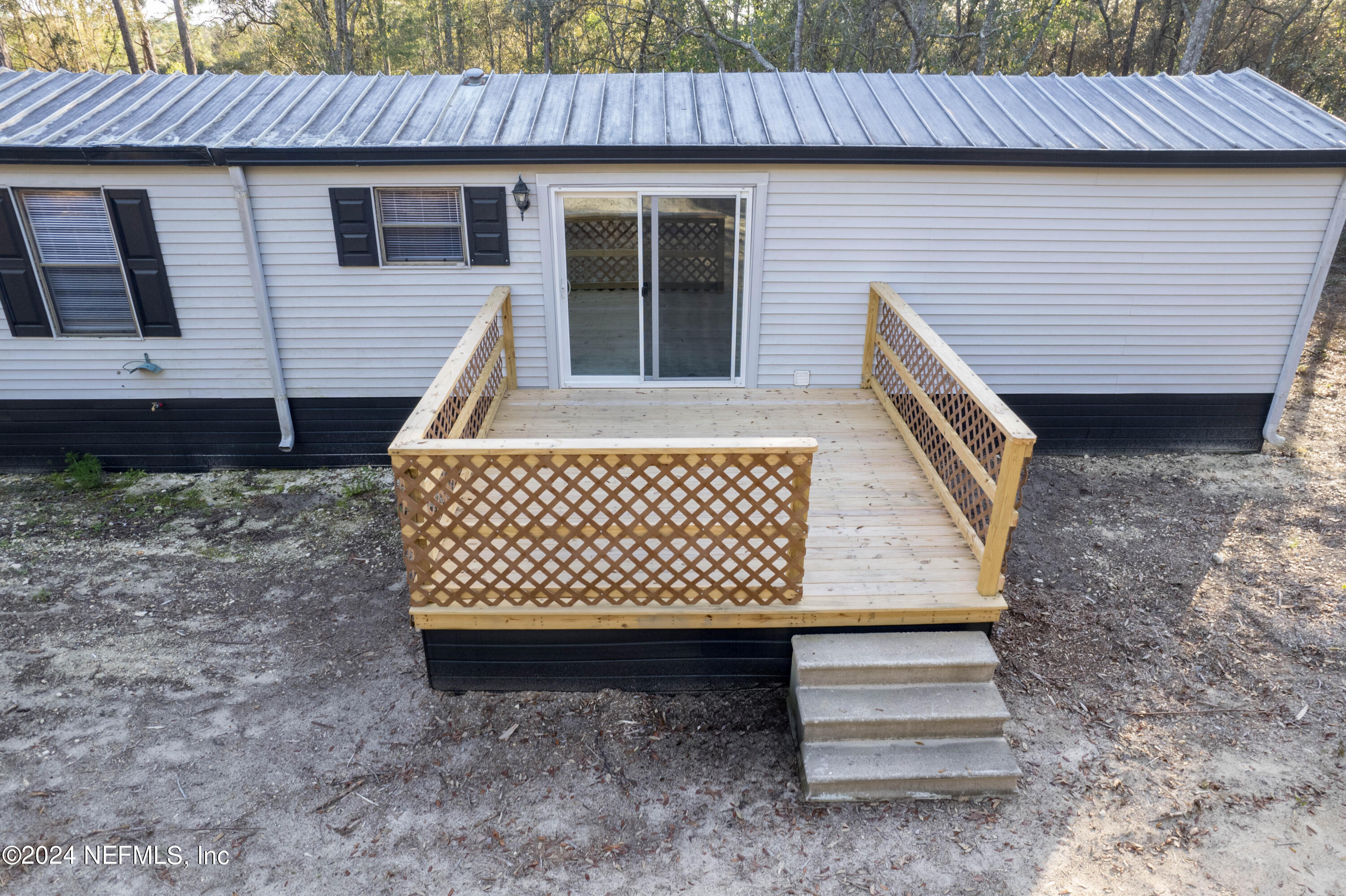 6787 Deer Springs Road Keystone Heights, FL 32656 - Photo 14 of 54 a view of a house with a yard and wooden fence