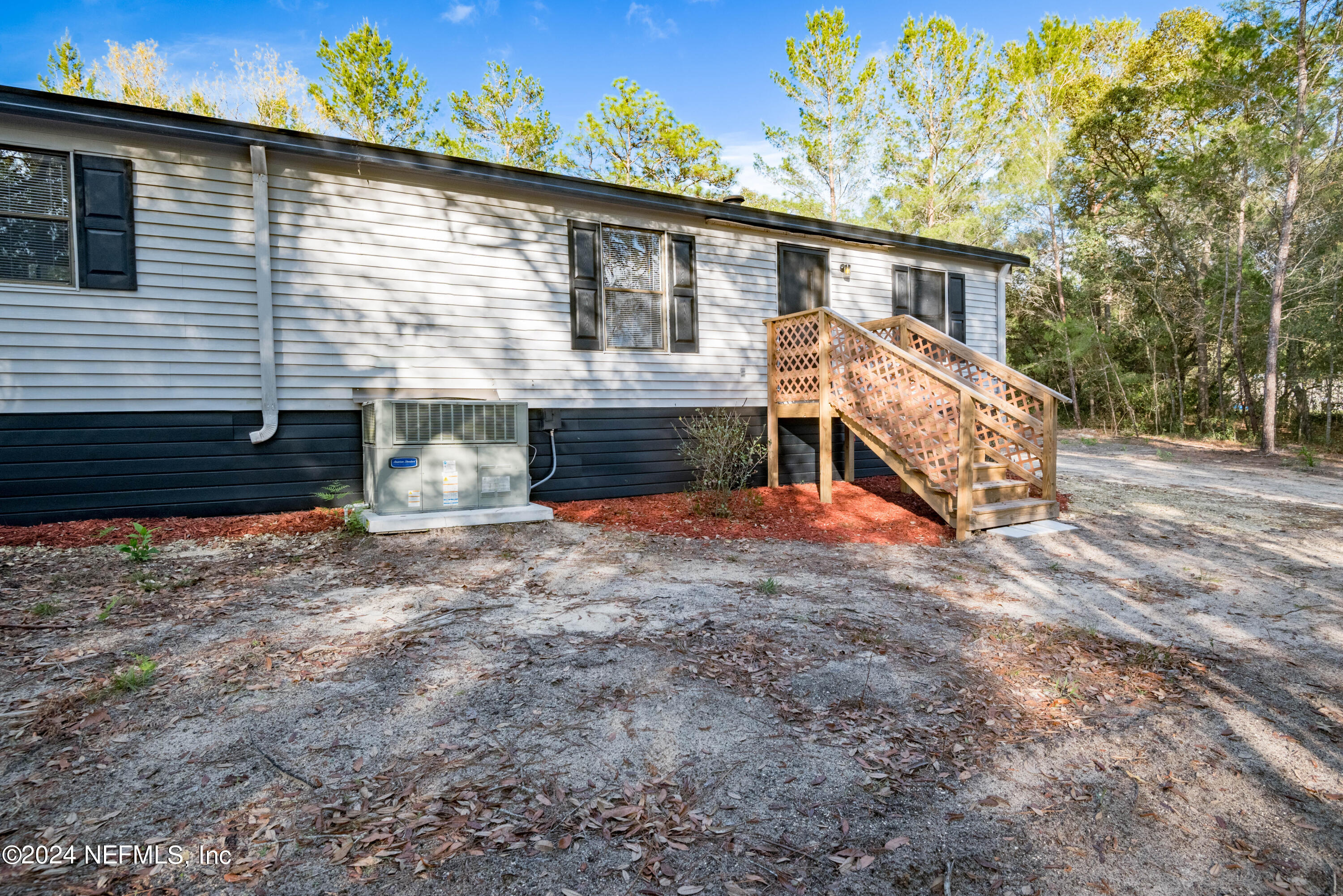 6787 Deer Springs Road Keystone Heights, FL 32656 - Photo 3 of 54 a front view of a house with a yard and garage