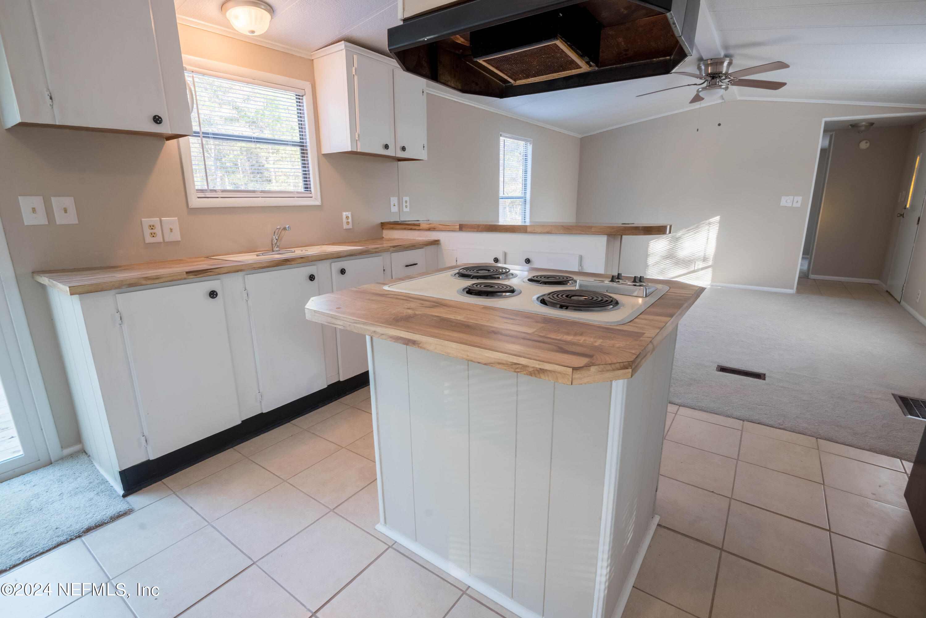 6787 Deer Springs Road Keystone Heights, FL 32656 - Photo 42 of 54 a kitchen with stainless steel appliances granite countertop a sink and a stove