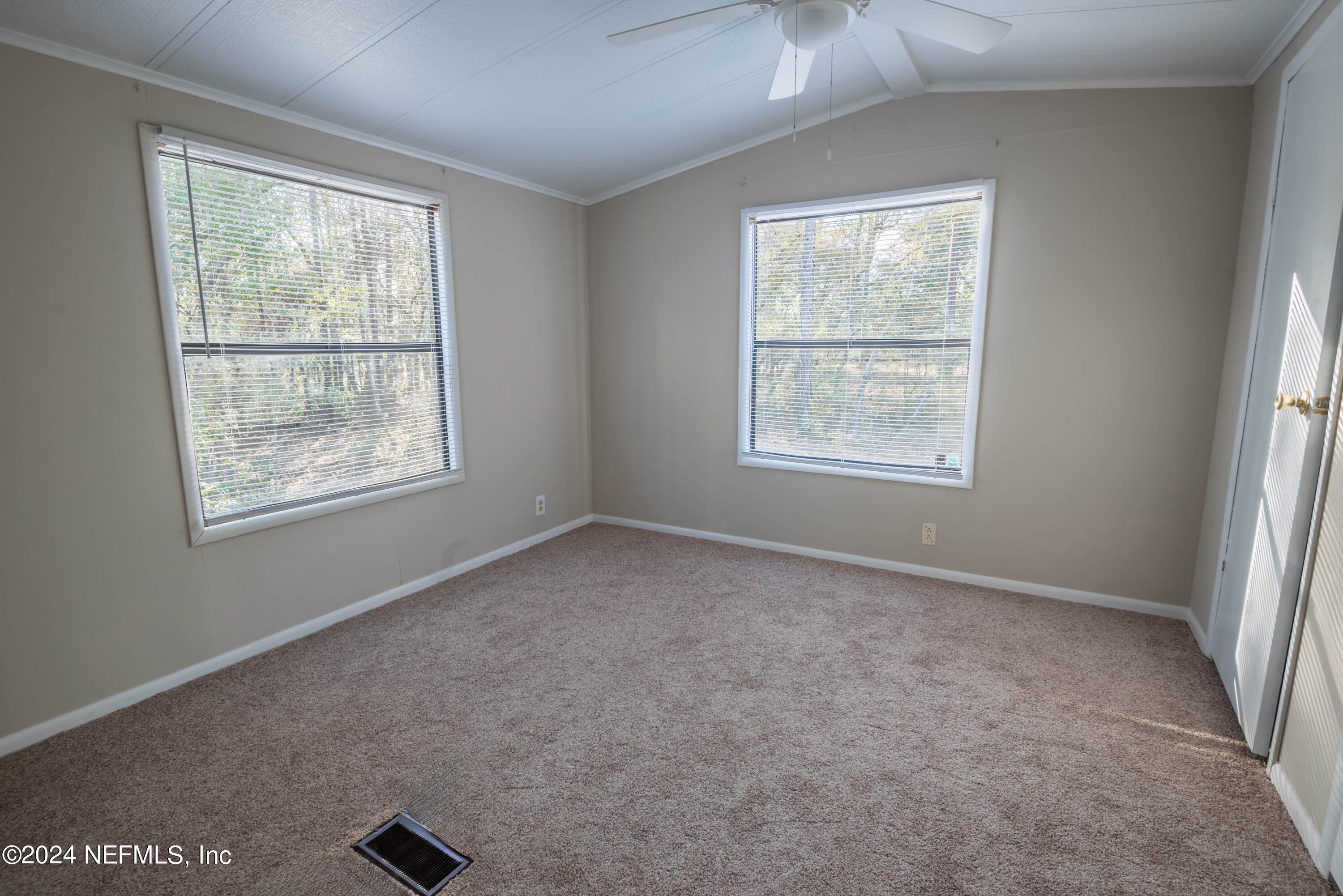 6787 Deer Springs Road Keystone Heights, FL 32656 - Photo 44 of 54 an empty room with windows