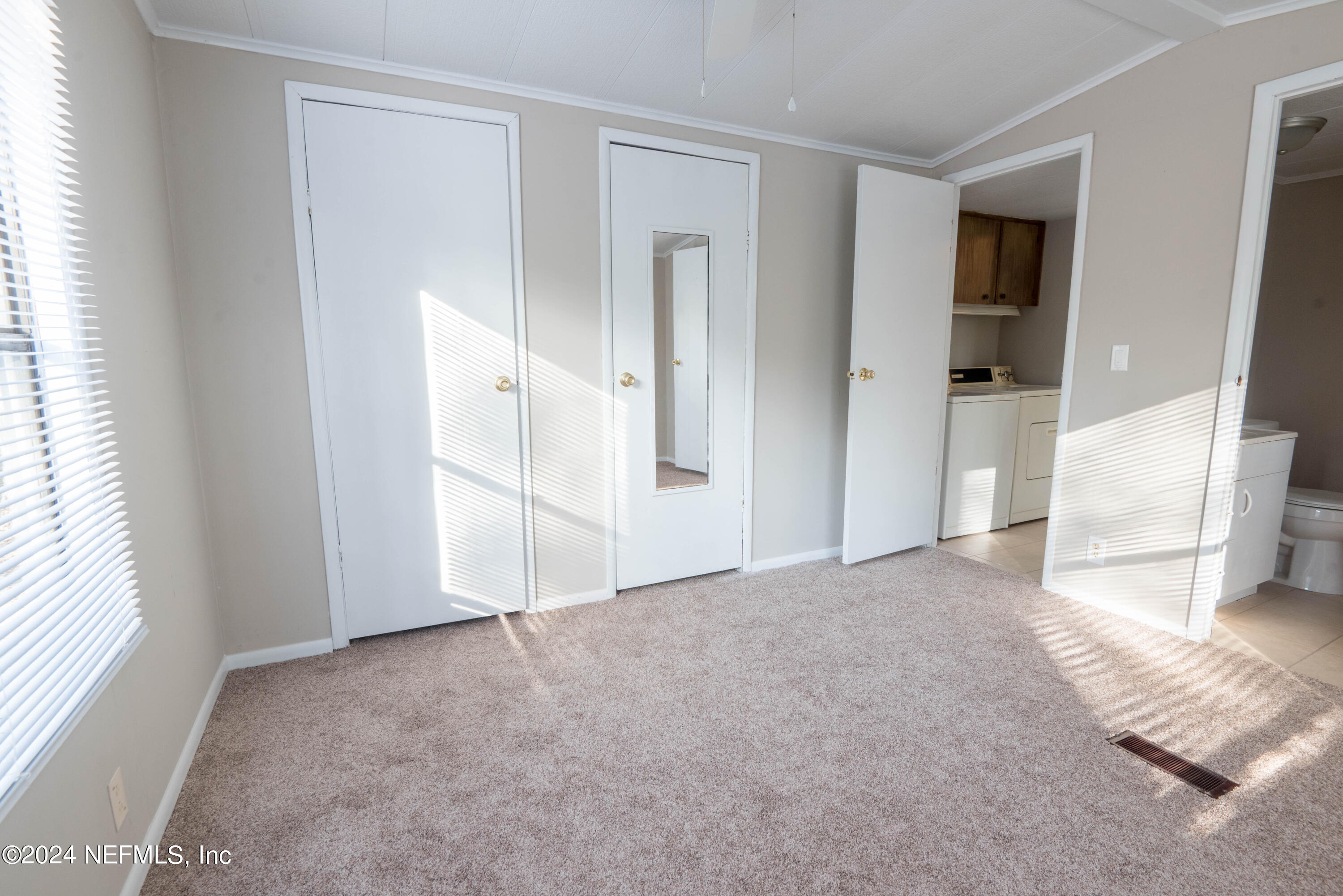 6787 Deer Springs Road Keystone Heights, FL 32656 - Photo 47 of 54 an empty room with windows and closet