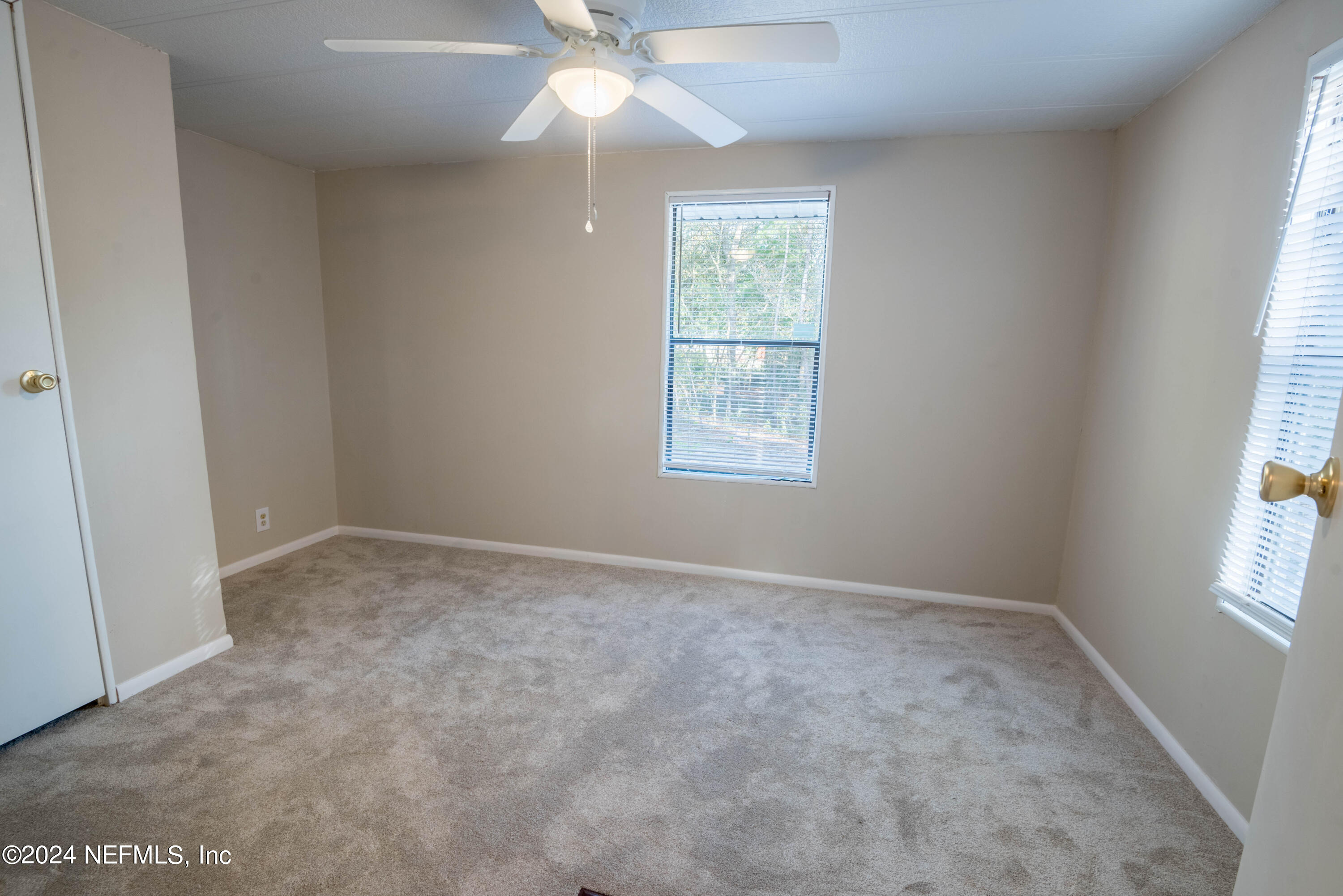6787 Deer Springs Road Keystone Heights, FL 32656 - Photo 53 of 54 an empty room with a window and a fan