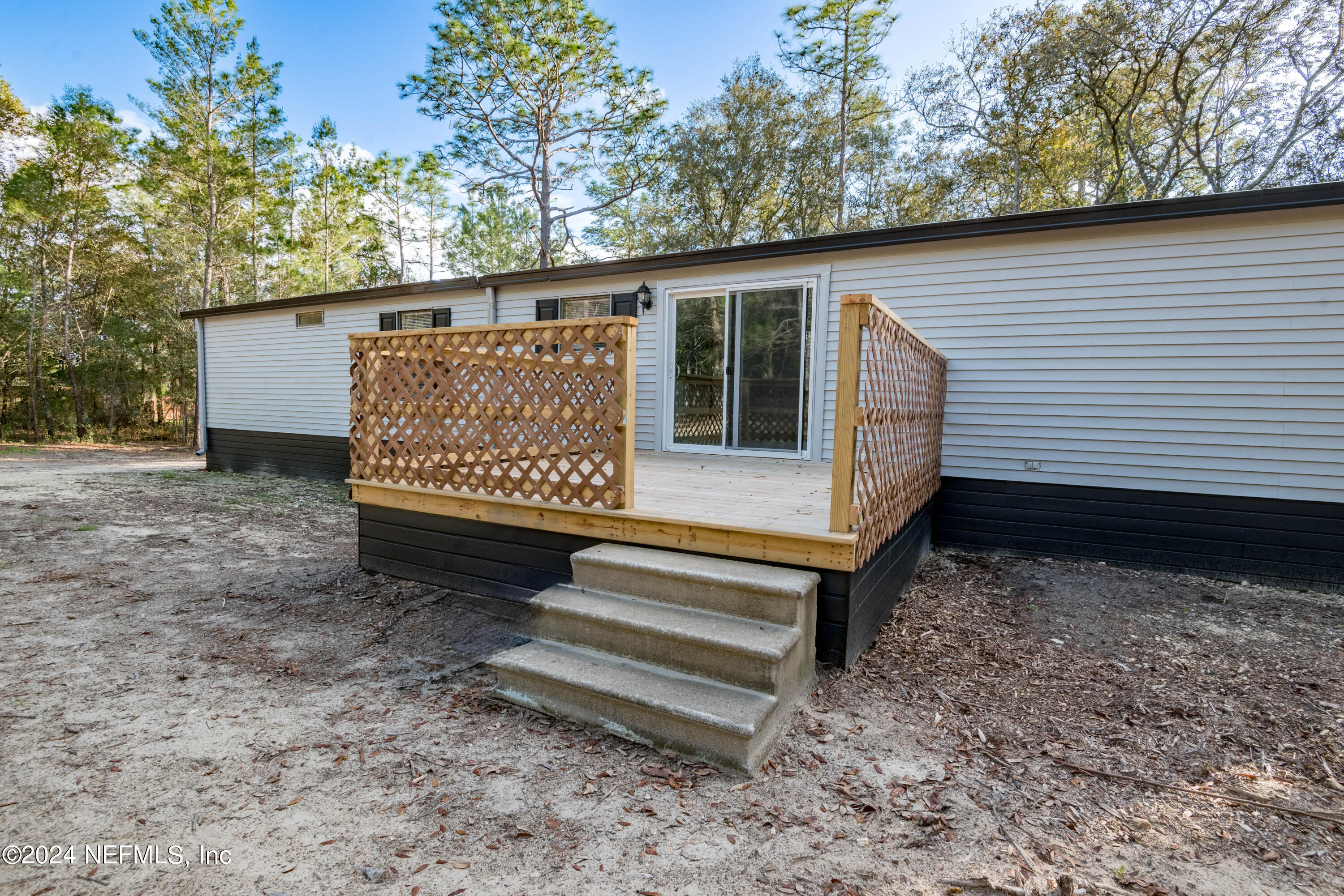 6787 Deer Springs Road Keystone Heights, FL 32656 - Photo 9 of 54 a view of a bench in the backyard