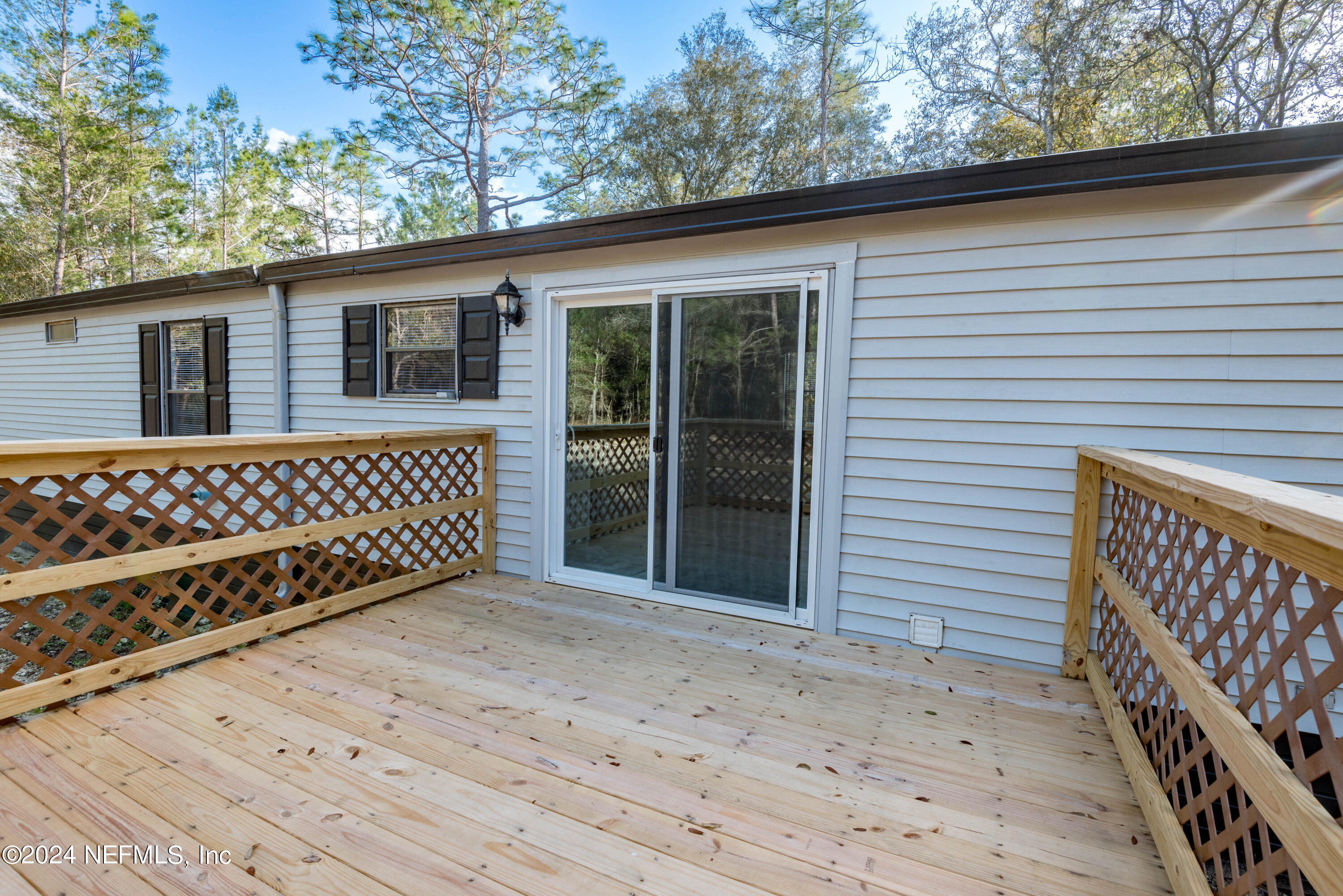 6787 Deer Springs Road Keystone Heights, FL 32656 - Photo 10 of 54 a view of a house with a deck