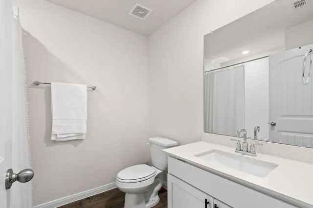 a bathroom with a sink toilet and vanity