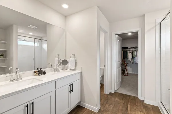 a view of walk in closet with clothes and shoes