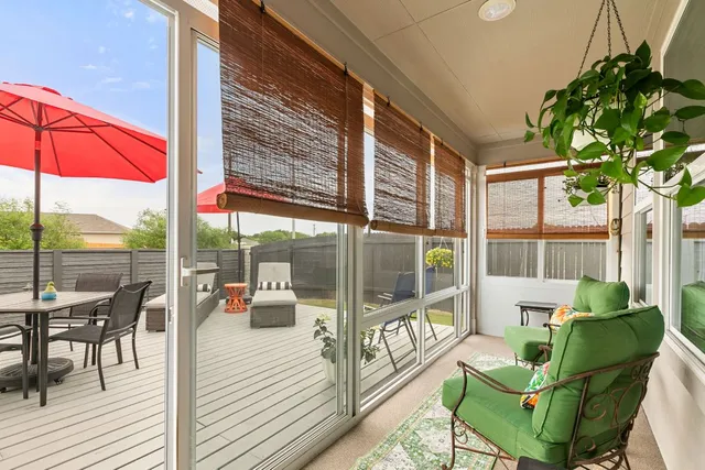a balcony with furniture and garden view