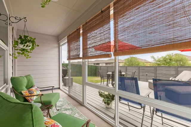 a view of a balcony with chair and a potted plant