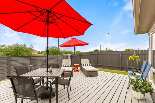 a view of deck with furniture and barbeque oven
