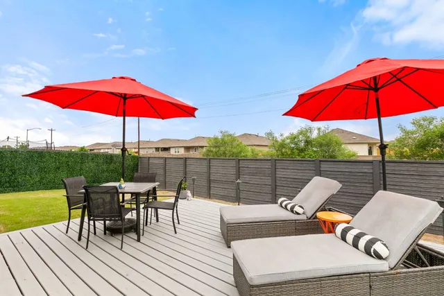 an outdoor sitting area with furniture and umbrella