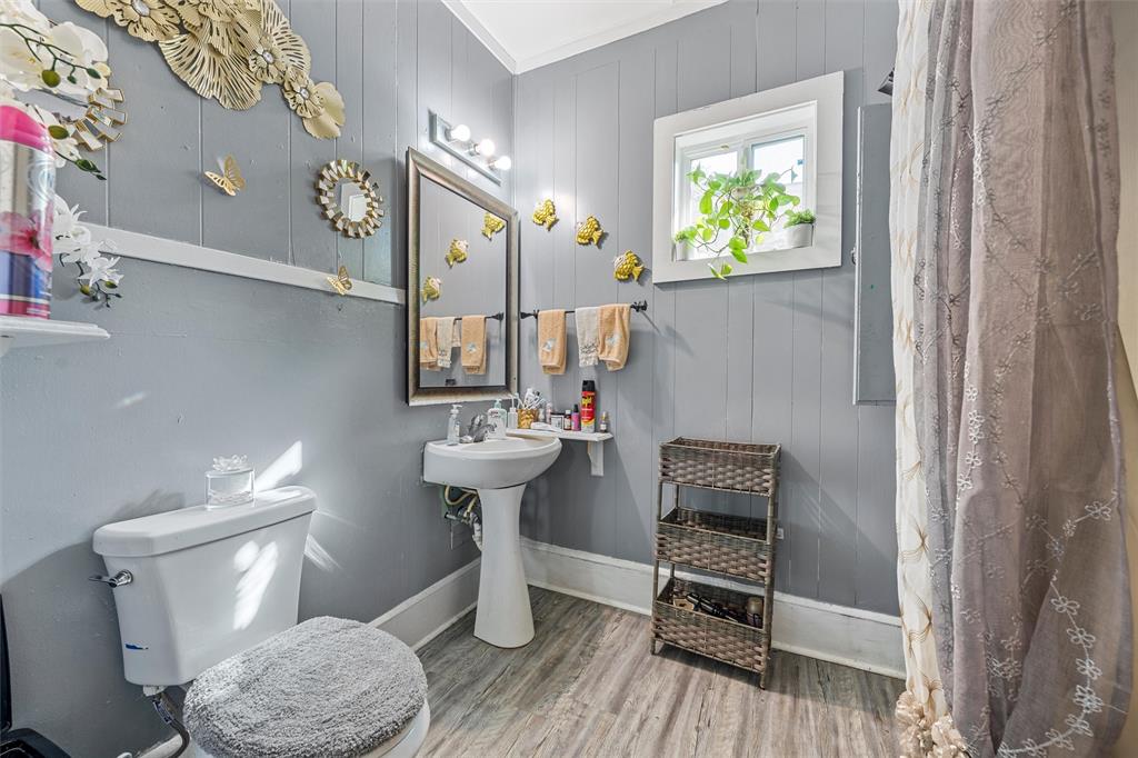 1615 Mitchell Avenue Waco, TX 76708 - Photo 11 of 14 a bathroom with a sink a toilet a mirror and shower