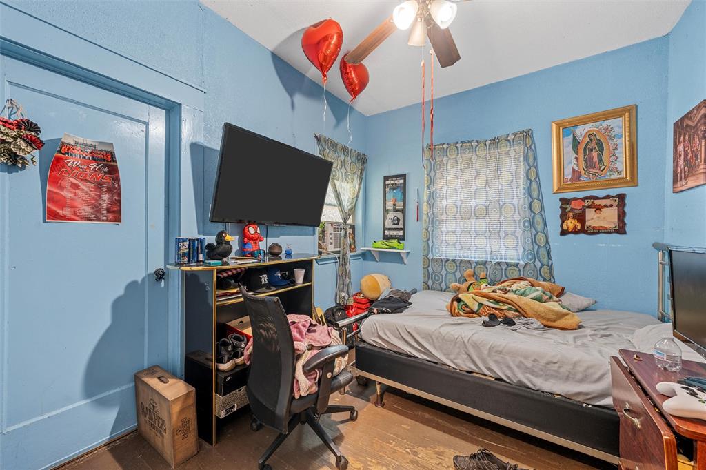 1615 Mitchell Avenue Waco, TX 76708 - Photo 13 of 14 a bedroom with bed and a flat screen tv