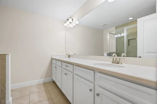 a bathroom with a double vanity sink and a mirror