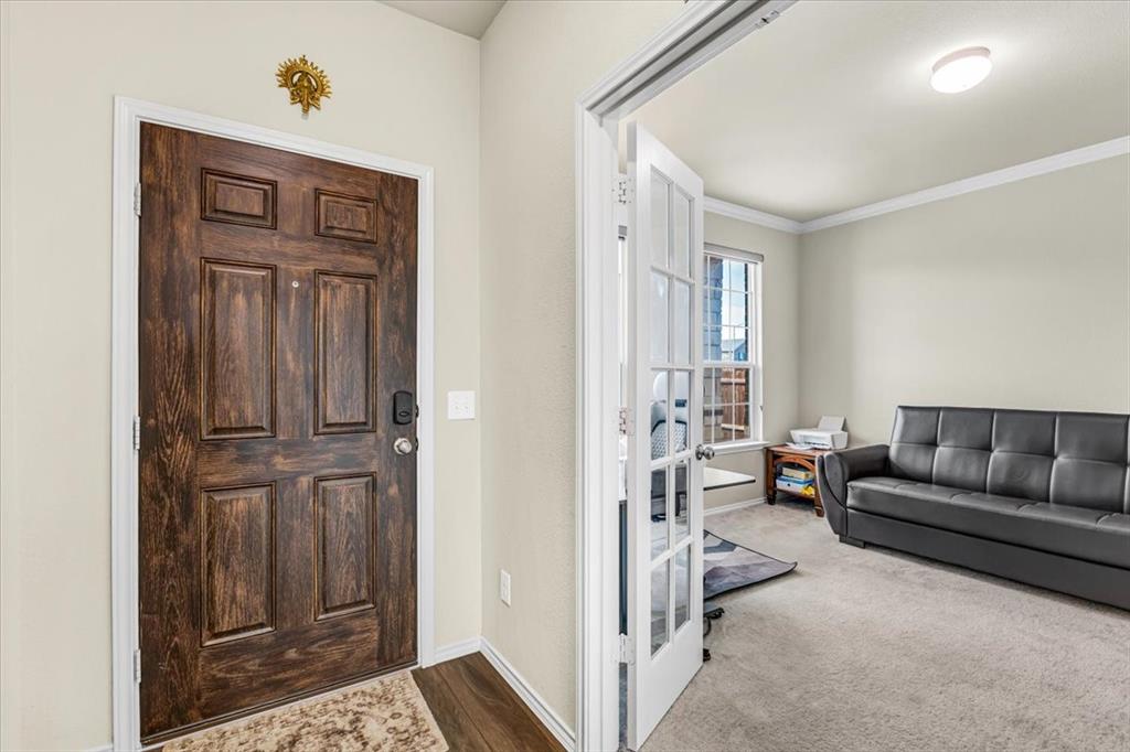 1201 Timberhurst Trail Fort Worth, TX 76131 - Photo 5 of 40 Entryway featuring a paneled wood-finish door with smart lock hardware and wood-finish flooring