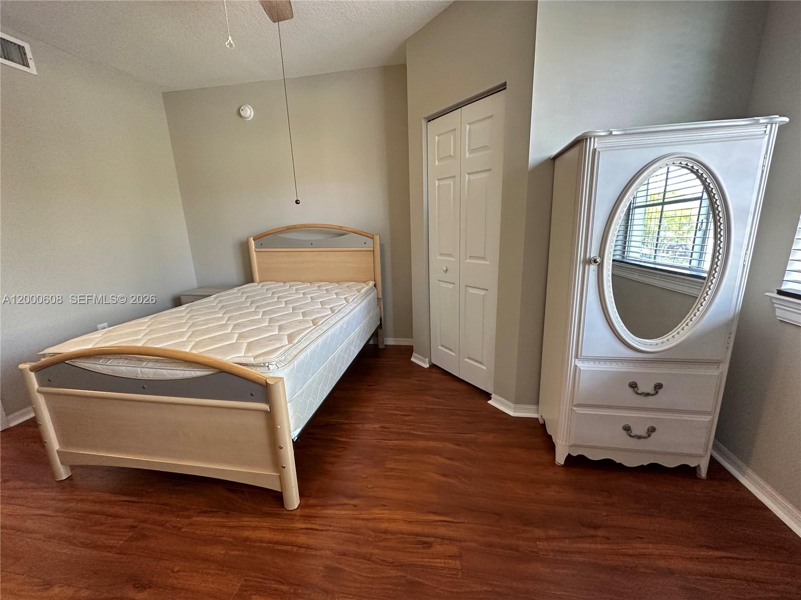 6841 Southwest 44th Street, Unit 209 Miami, FL 33155 - Photo 13 of 20 a spacious bedroom with a bed and a window