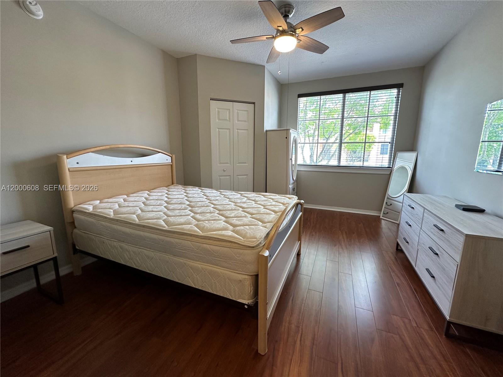6841 Southwest 44th Street, Unit 209 Miami, FL 33155 - Photo 15 of 20 a bedroom with a bed and a chandelier