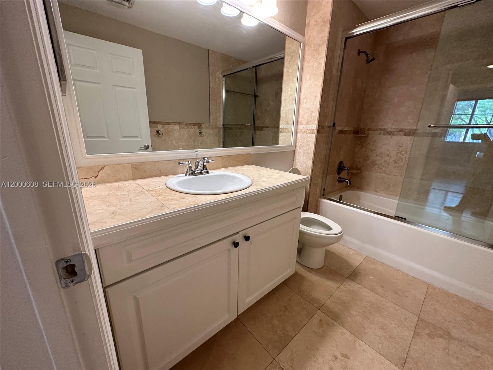 6841 Southwest 44th Street, Unit 209 Miami, FL 33155 - Photo 16 of 20 a bathroom with a sink a toilet and shower