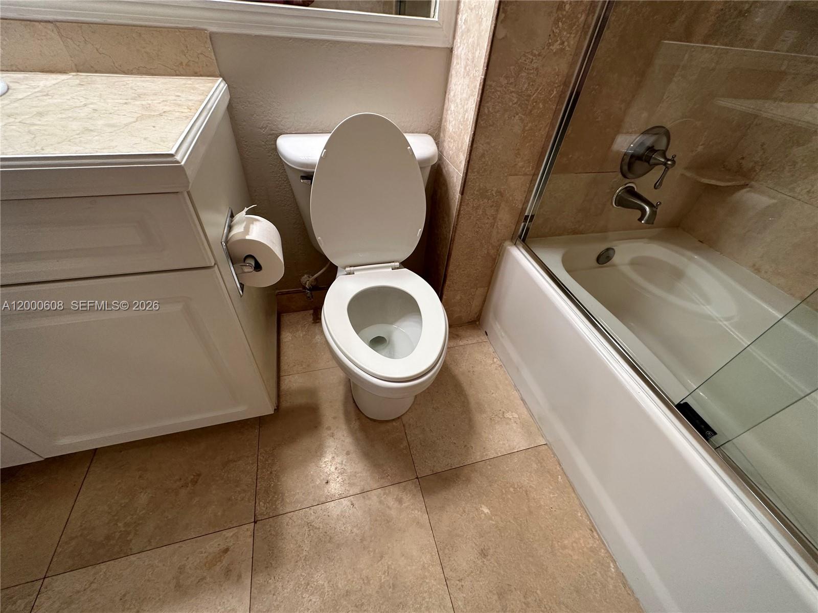 6841 Southwest 44th Street, Unit 209 Miami, FL 33155 - Photo 17 of 20 a bathroom with a toilet sink and mirror