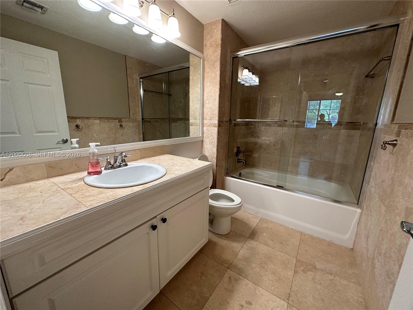 6841 Southwest 44th Street, Unit 209 Miami, FL 33155 - Photo 18 of 20 a bathroom with a sink a toilet and shower