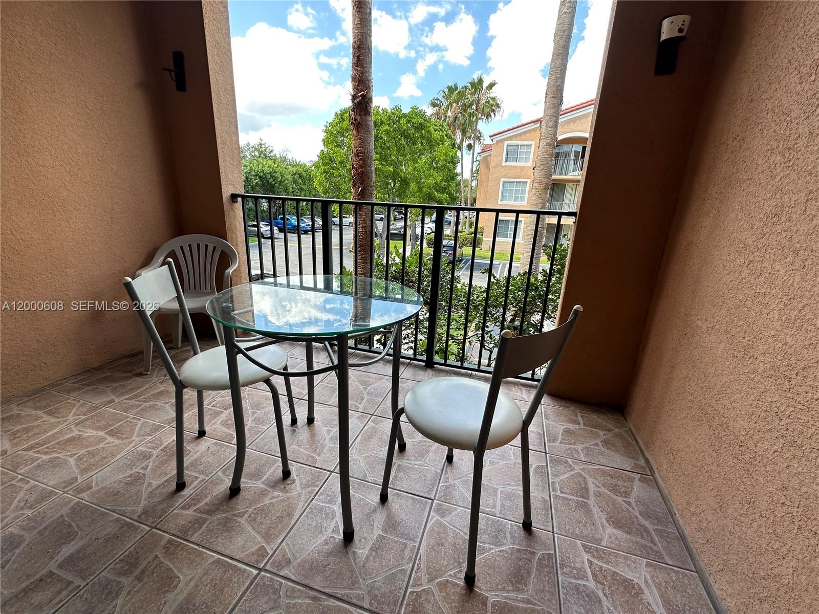 6841 Southwest 44th Street, Unit 209 Miami, FL 33155 - Photo 4 of 20 a view of a balcony with furniture
