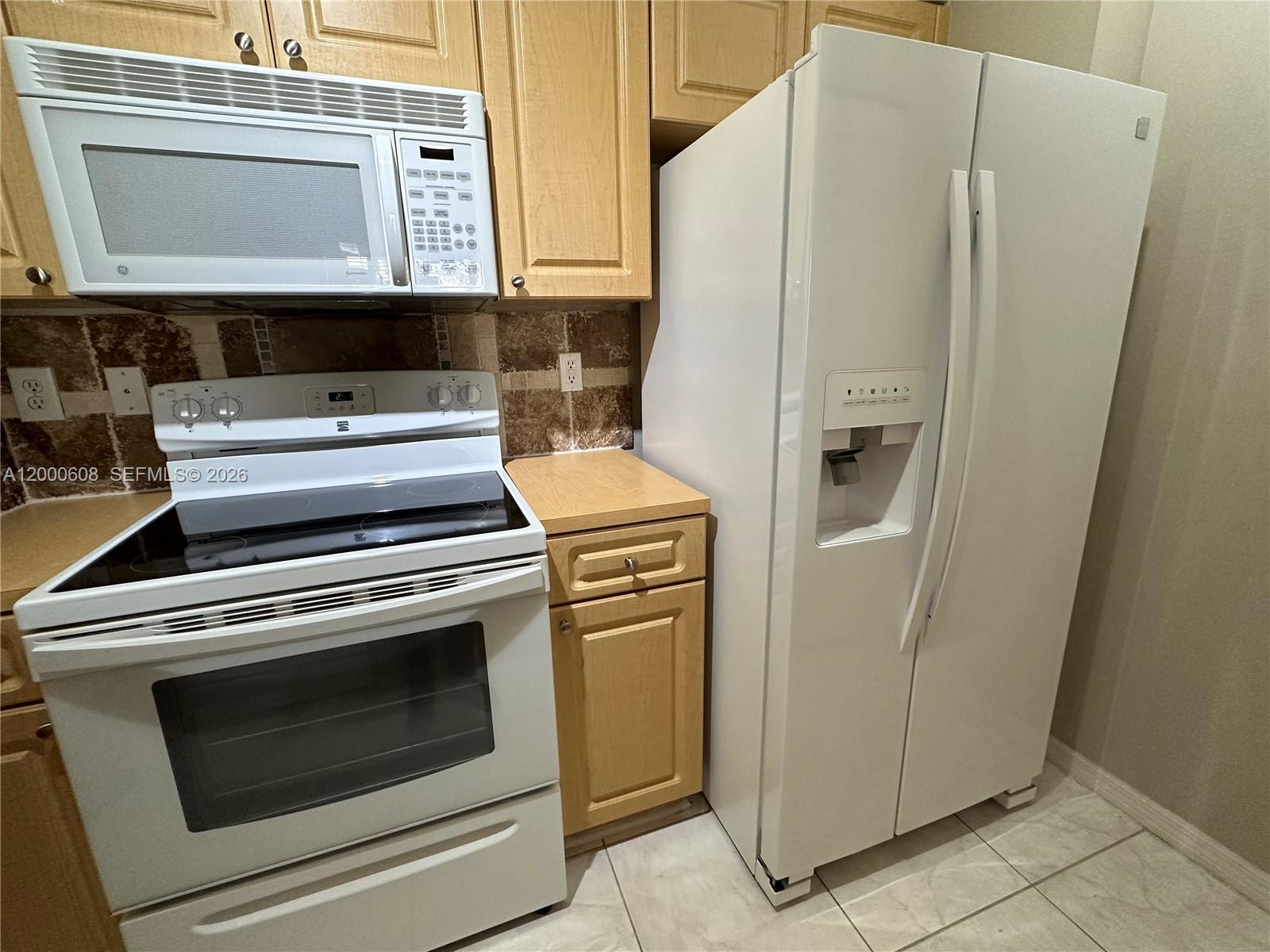 6841 Southwest 44th Street, Unit 209 Miami, FL 33155 - Photo 6 of 20 a close view of a stove and cabinets