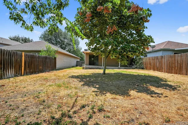 a backyard of a house with portable swimming pool and basket ball court