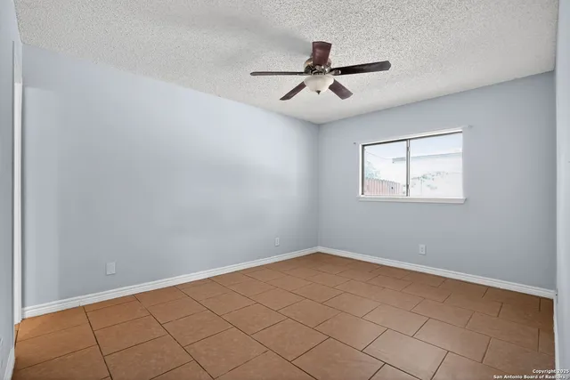 a view of a big room with wooden floor and windows