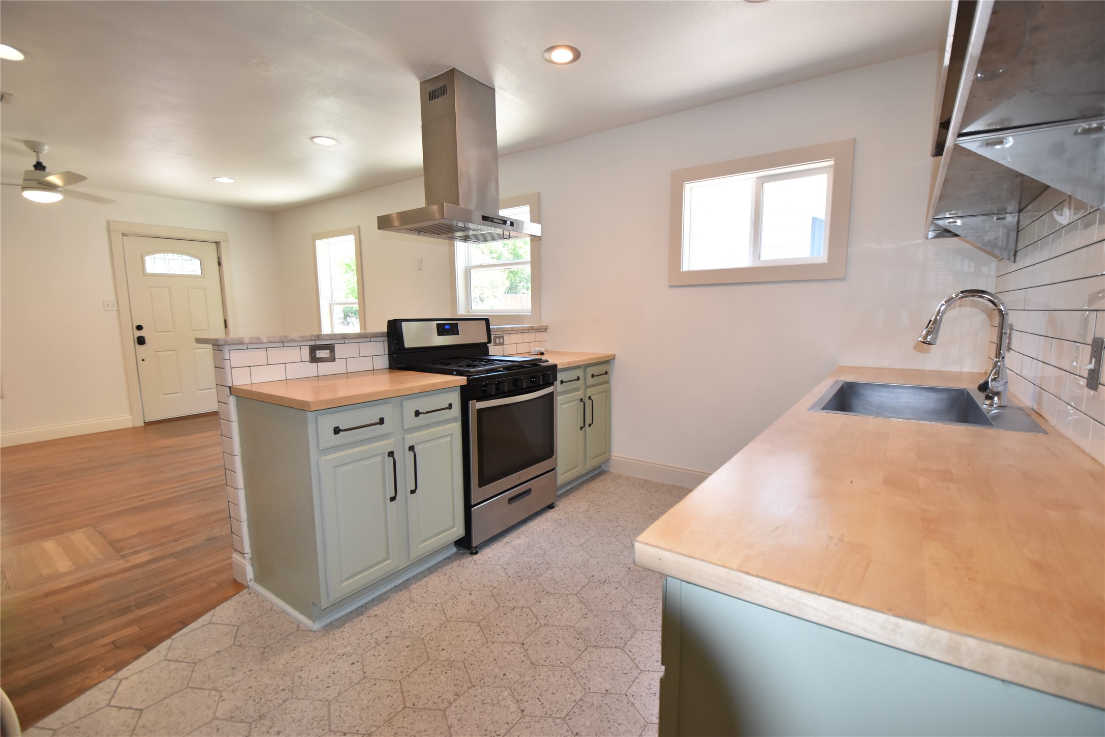 2012 Payne Avenue, Unit A Austin, TX 78757 - Photo 11 of 33 Kitchen featuring light wood countertops, subway tile backsplash, stainless steel appliances, and a stainless appliances