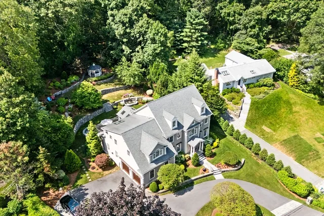 an aerial view of a house with a yard