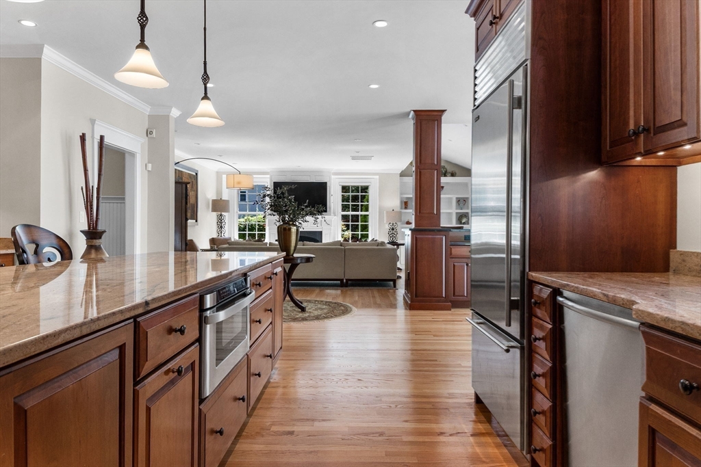 143 Lincoln Street Lexington, MA 02421 - Photo 12 of 42 a open kitchen with stainless steel appliances granite countertop a lot of counter space and wooden floors