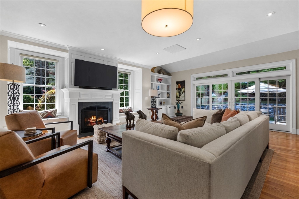 143 Lincoln Street Lexington, MA 02421 - Photo 15 of 42 a living room with furniture a large window and a fireplace