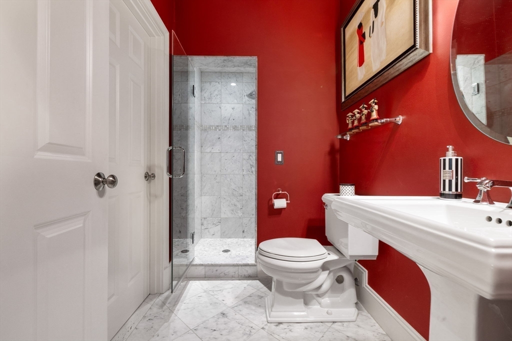 143 Lincoln Street Lexington, MA 02421 - Photo 22 of 42 a white toilet sitting next to a bathroom sink