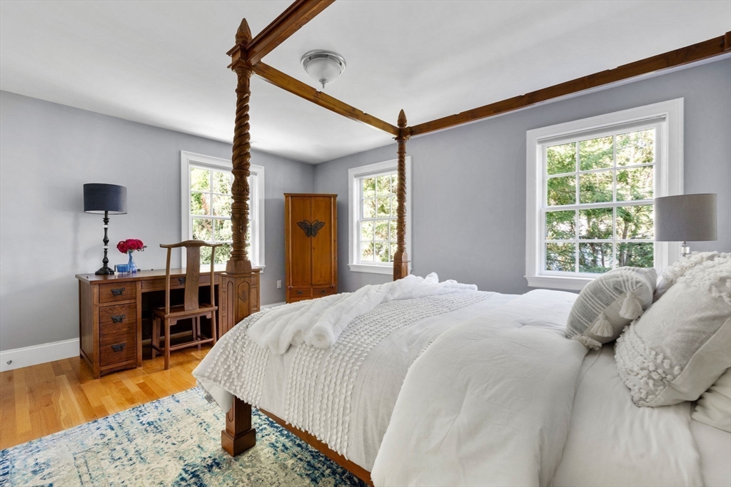 143 Lincoln Street Lexington, MA 02421 - Photo 27 of 42 a bedroom with a bed and a dresser with wooden floor