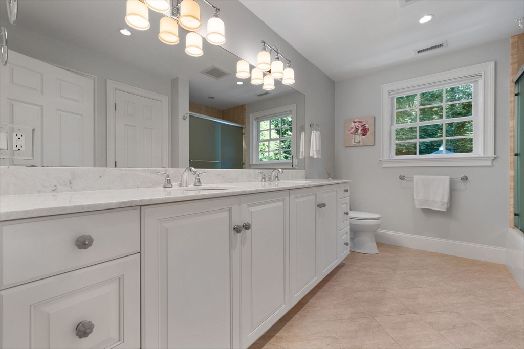 143 Lincoln Street Lexington, MA 02421 - Photo 28 of 42 a bathroom with a sink a large mirror and a toilet