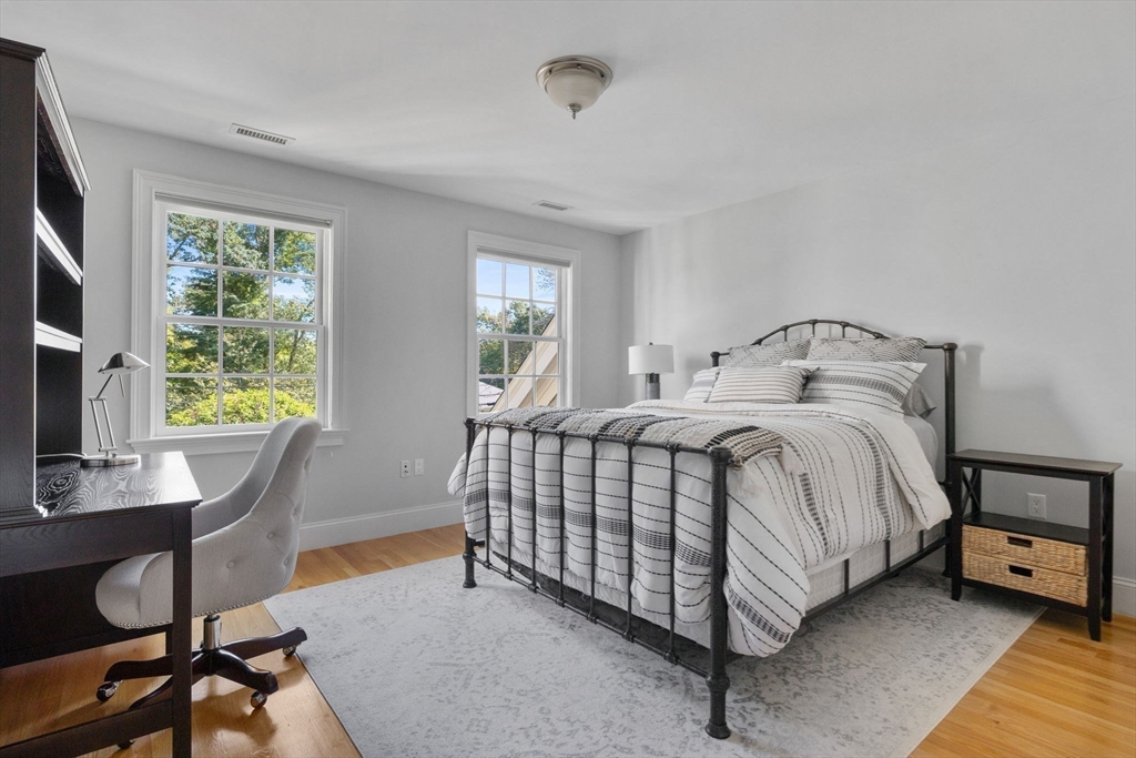 143 Lincoln Street Lexington, MA 02421 - Photo 29 of 42 a bedroom with a bed a desk and chair with window