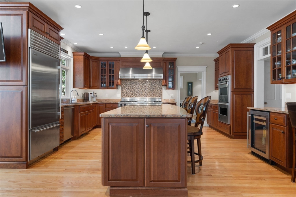143 Lincoln Street Lexington, MA 02421 - Photo 8 of 42 a kitchen with stainless steel appliances granite countertop a refrigerator a stove and a wooden floors