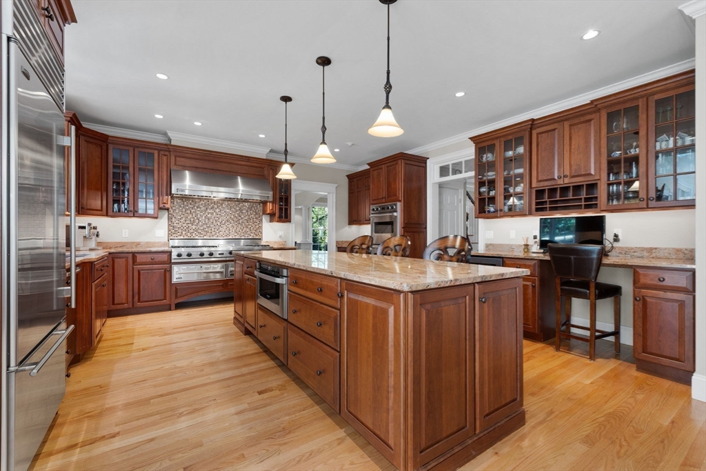 143 Lincoln Street Lexington, MA 02421 - Photo 9 of 42 a kitchen with stainless steel appliances granite countertop a stove a sink a oven and a refrigerator