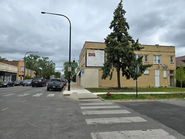 a view of a street with cars parked