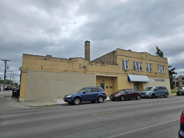 a view of a car is parked in front of a building