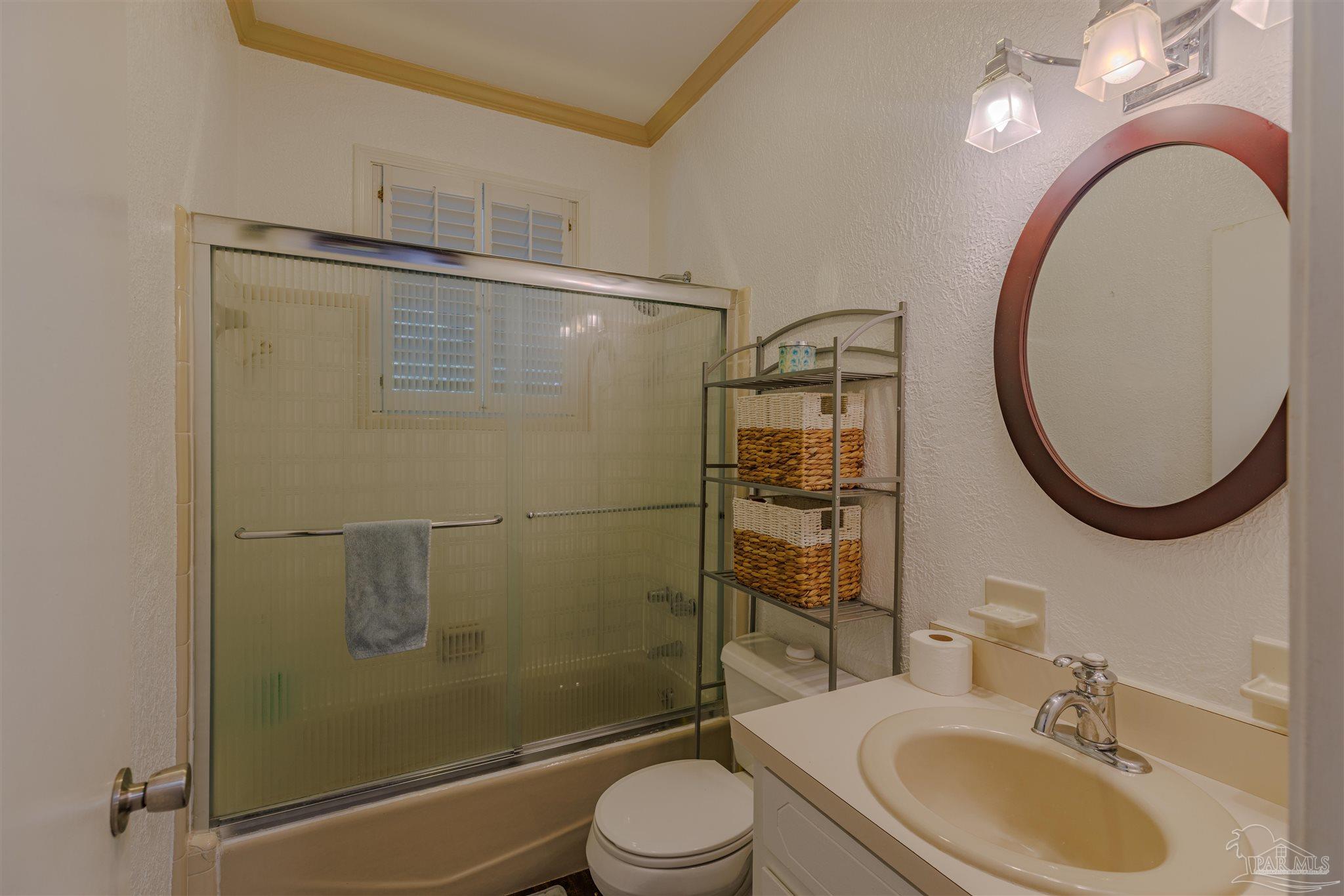 5049 Guernsey Road Pace, FL 32571 - Photo 35 of 61 a bathroom with a sink toilet and a mirror