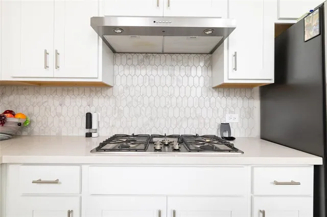 a kitchen with a stove and cabinets