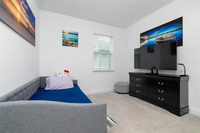 a bedroom with a bed and a dresser