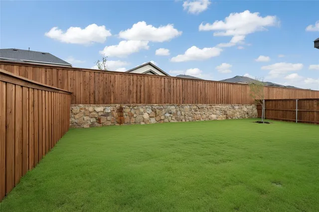a view of yard with wooden fence