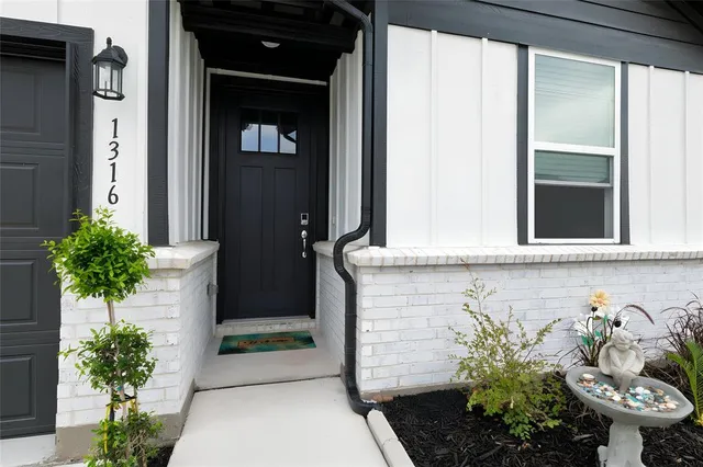 a front view of a house with a potted plant and garage