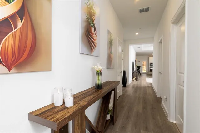 a view of a hallway with wooden floor and staircase