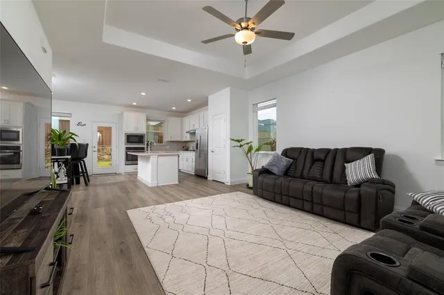 a living room with furniture and kitchen view